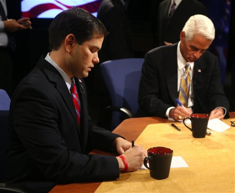 Republican Marco Rubio, left, and Independent Charlie Crist take notes before the start of their debate at the studios of WESH-TV in Winter Park, Fla., on Tuesday.